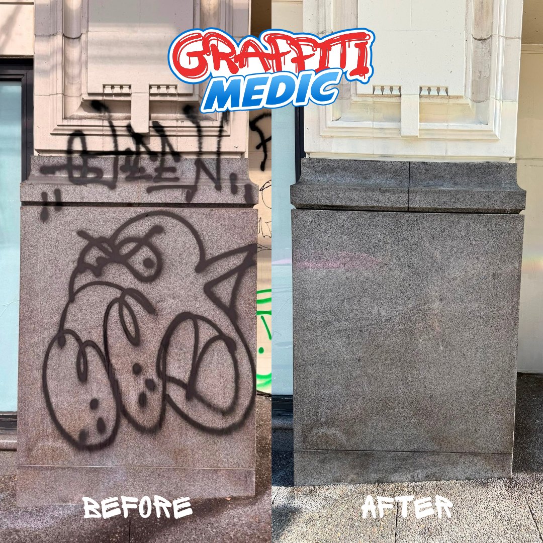 Black spray tags removed from granite and stone building base — Graffiti Medic before and after
